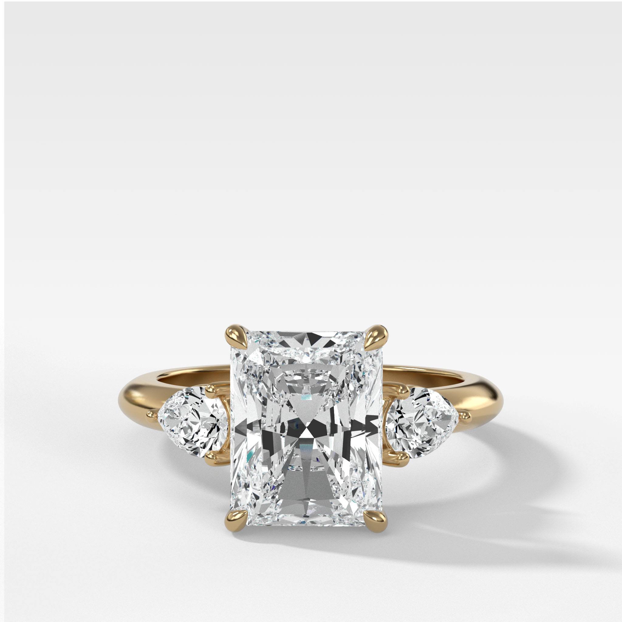 Three Stone Engagement Ring With Pear Side Stones and Elongated Radiant Cut Diamond